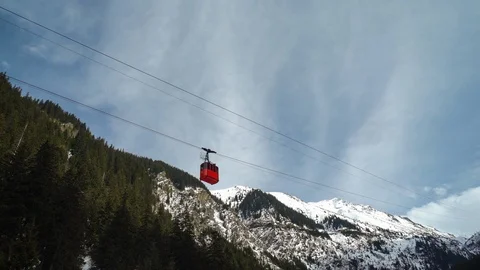 Red cable-car moving on a snowy mountain during winter sunny day Transfagarasan Stock Footage 98239380