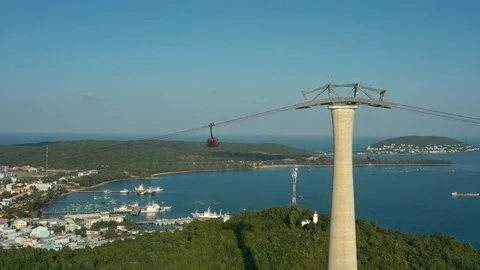 Red cable car over town in the south of Phu Quoc island Vietnam in sunset with Stock Footage 124366280