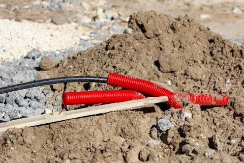 A red cable is laying on the ground Stock Photos