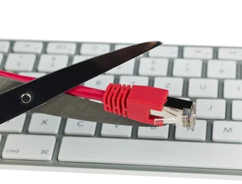 The red cable of a network from a computer. Disconnected with scissors. Austria Stock Photos