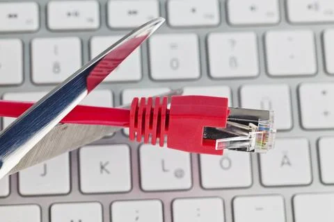The red cable of a network from a computer. Disconnected with scissors. Austria Stock Photos