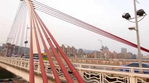 Red cables of cable-stayed bridge, closeup perspective, traffic on back Stock Footage 58143004