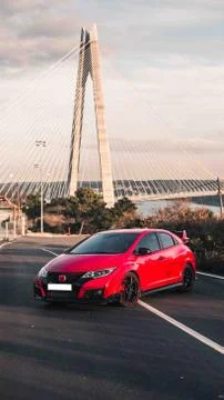 Red cabriolet oarking on the hill with view Stock Photos