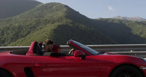 Red Cabriolet at Sunset Orange Glow Outdoor Shot Stock Footage 159350497