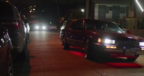 Red Cadillac Crusing Down the Urban Street at Night (Red Komodo Footage) Stock Footage 303930505