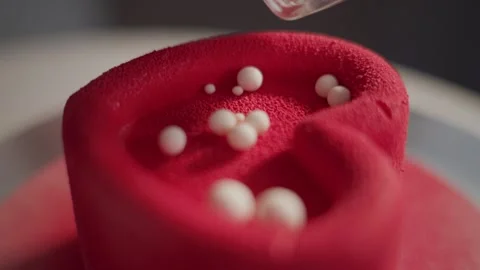 Red cake adorned with white sugar pearls Stock Footage 336193157