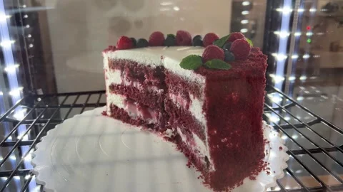 Red cake with cream and raspberry flavor, a piece of sweet dessert red cake with Stock Footage 311953795