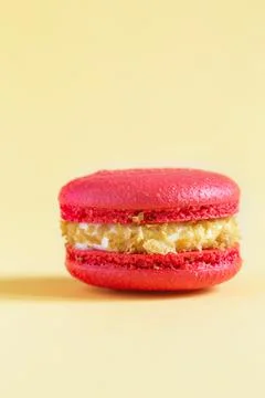 Red Cake macaron or macaroon on yellow background. Stock Photos