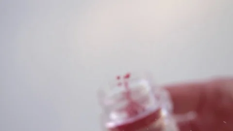 Red cake sprinkles falling towards camera in super slow motion Stock Footage 75264413