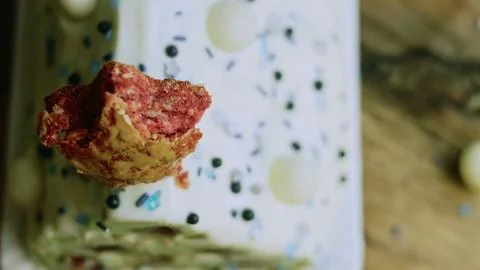 Red cake star bite displayed against white frosting Stock Photos