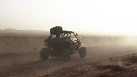 Red Can-Am UTV Side-by-Side Buggy Racing Through Desert Kicking Up Dust Cloud Stock Footage 332895016