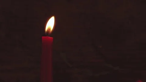 Red candle almost blown out by wind Stock Footage 80350852
