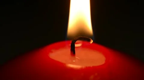 Red candle on a black background Stock Footage 21726405