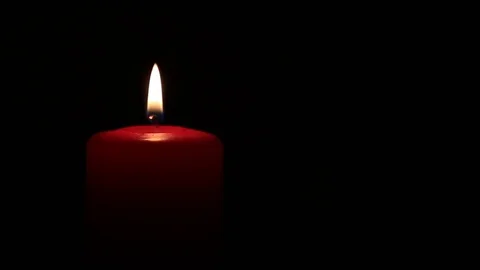 Red candle burning on black background Stock Footage 74783229