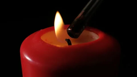 Red candle burning on black background. Red wax candle burning. Close-up Stock Footage 144472422