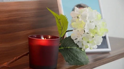 Red candle burning in the front the image of the deceased. Stock Footage 70198363