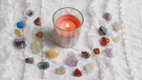 A red candle burns on an altar with crystals and white lace Stock Footage 119028047