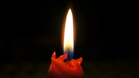 Red candle burns in the dark. Macro. Stock-Footage 37751696