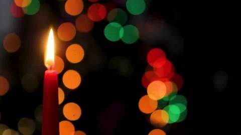 Red candle on a dark background, Christmas candle on bokeh lights background Stock Footage 83537600