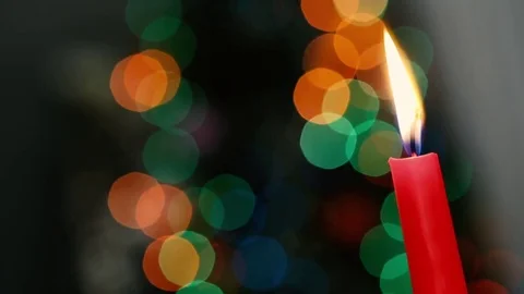 Red candle on a dark background, Christmas candle on bokeh lights background Vidéo 84560341
