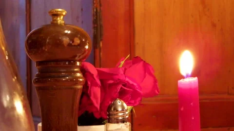 Red Candle at dinning table with roses and black pepper Stock Footage 51212725