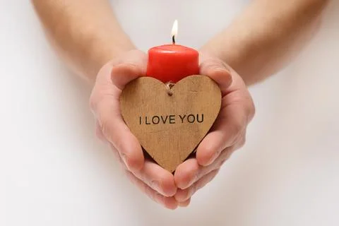 Red candle in hands Stock Photos