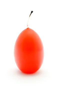 This is a red candle in the shape of an egg Foto stock
