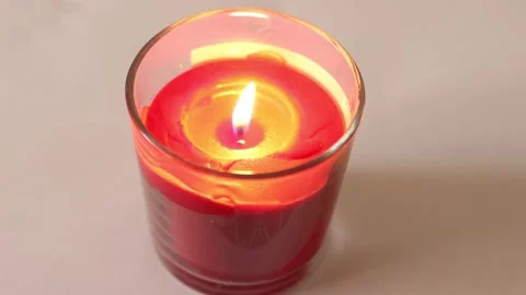 The red candle shines. Close-up image of a fragrant candle. Stock Footage 131852540