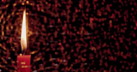 Red Candle visible screen left through pane of soft focus fractured/broken glass Stock Footage 339026688