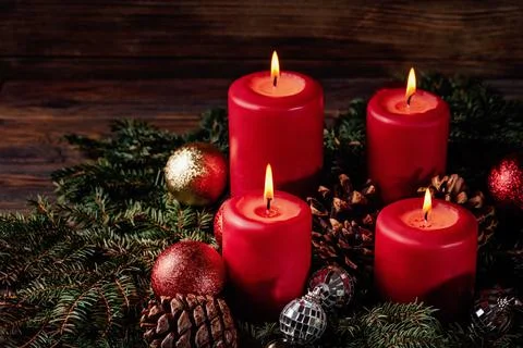 Red candles in advent wreath decoration on wooden dark background Stock Photos