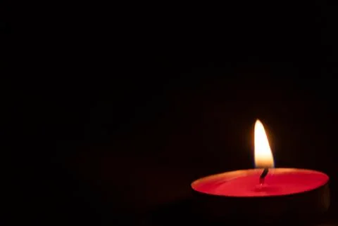 Red candles on a black background. Fire in the dark. Candle light. Light it u Stock Photos