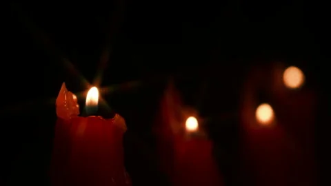 Red candles burning on a black background Stock Footage 322961908