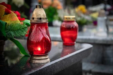Red candles on the grave devoted to All Souls Day 写真素材