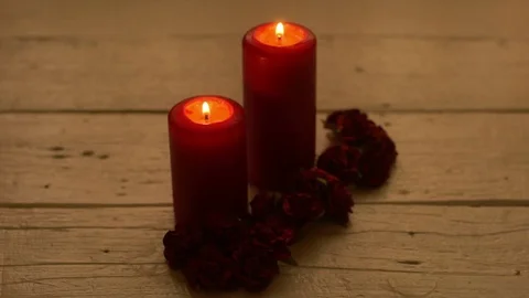 Red candles light with rose on white wooden desk Stock Footage 84160141