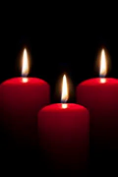 Red candles lighting in the darkness Stock Photos