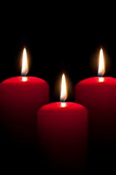 Red candles lighting in the darkness Stock Photos