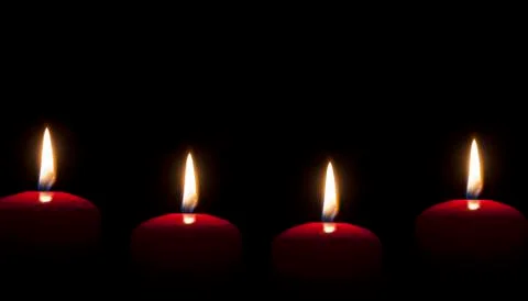 Red candles lighting in the darkness Stock Photos