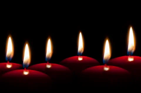Red candles lighting in the darkness Stock Photos