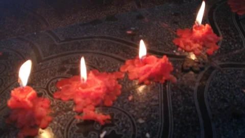 Red candles lit in a pagan worship ritual, in slow motion Stock Footage 165420153