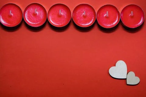 Red candles on a red background Stock Photos