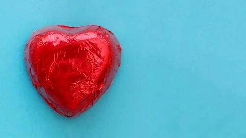 Red candy on a blue background. Stock Photos