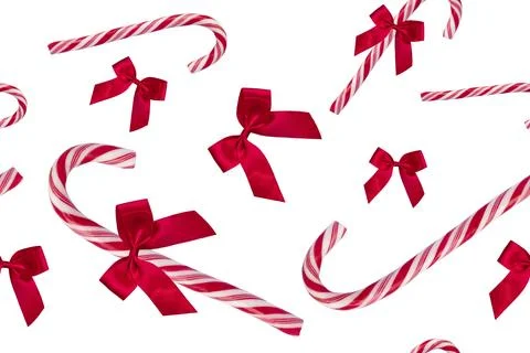 Red candy cane and red bow. Pattern. On white background. Stock Photos
