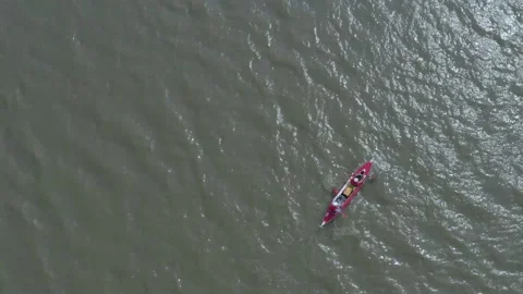 A red canoe runs through the river. Stock Footage 131375941