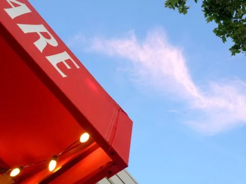 Red canopy awning with yellow light bulbs abstract background with blue sky Stock Photos