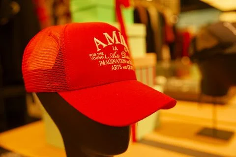 Red cap featuring creative design displayed on a mannequin in a vibrant ret.. Stock Photos