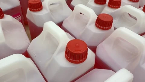 Red capped plastic jugs arranged in rows, ideal for industrial or storage b.. Stock Footage 319683422