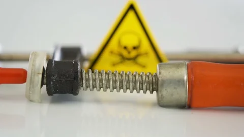 A red capsule on the clamp tool on the table Stock Footage 129458450