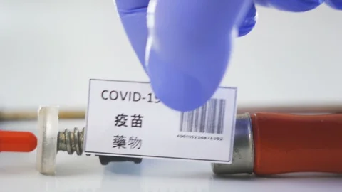 A red capsule coronavirus or Covid-19 written in Chinese Stock Footage 129337294