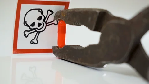 The red capsule on the jaw of the rusty pliers Stock Footage 129453495