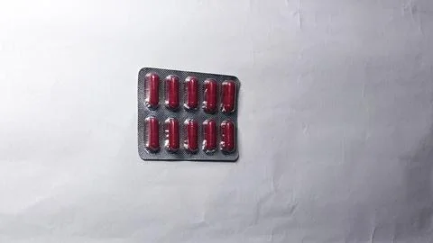 Red Capsules in Blister Pack: Precision Dosing in a Compact Design Stock Photos